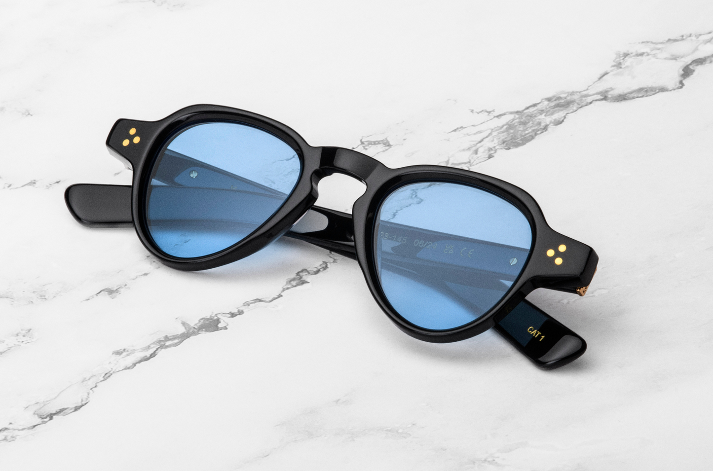 round black sunglasses with blue lenses