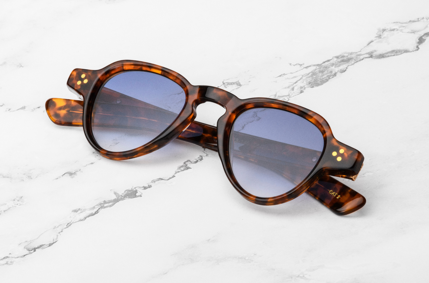round brown sunglasses with blue lenses