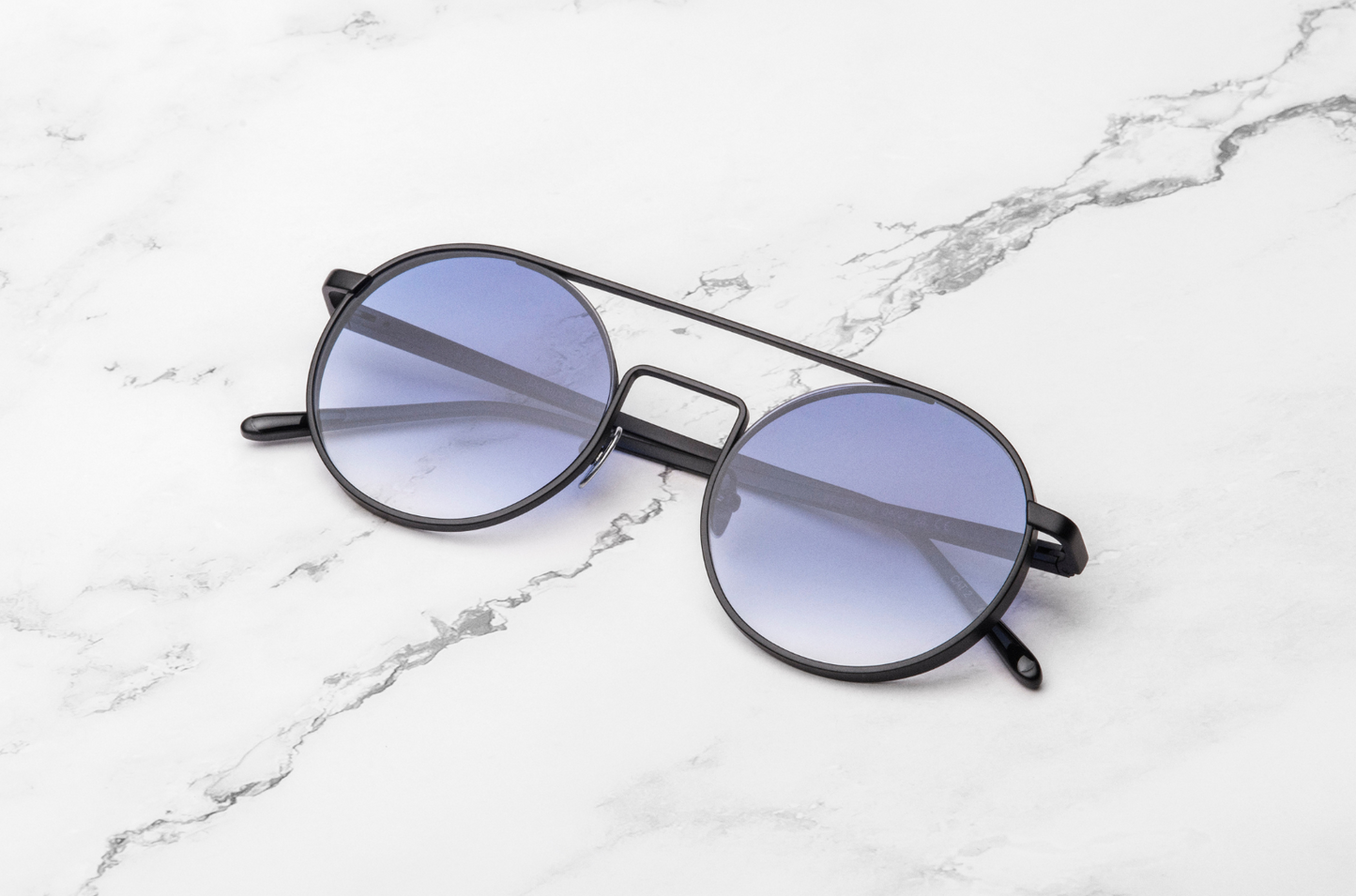 Round frame sunglasses with smokey blue lenses