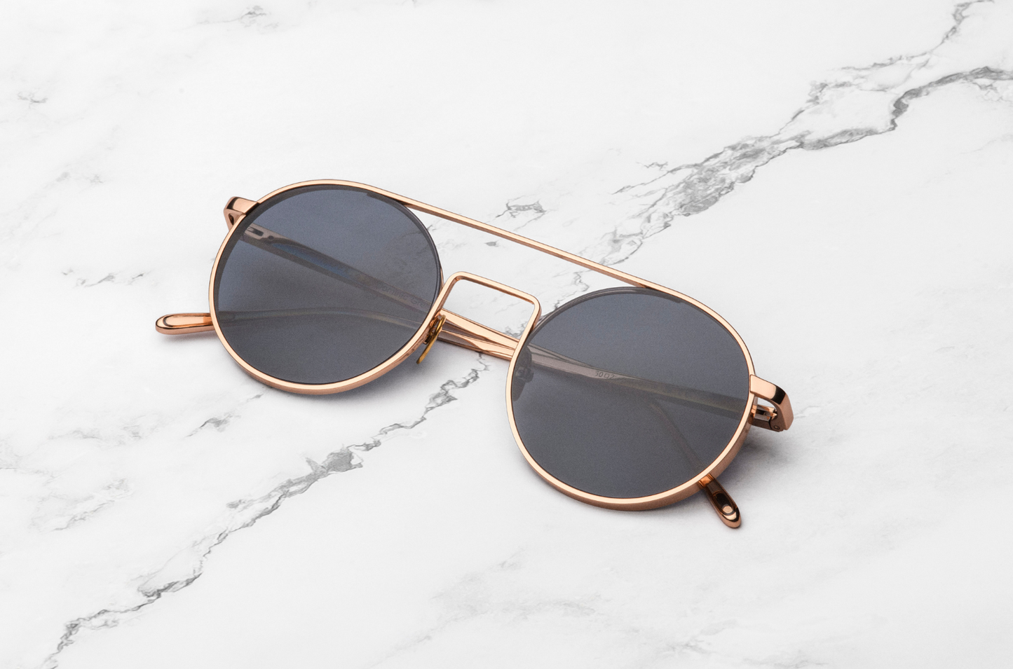 Rose gold round sunglasses with polarized lenses by Kopajos
