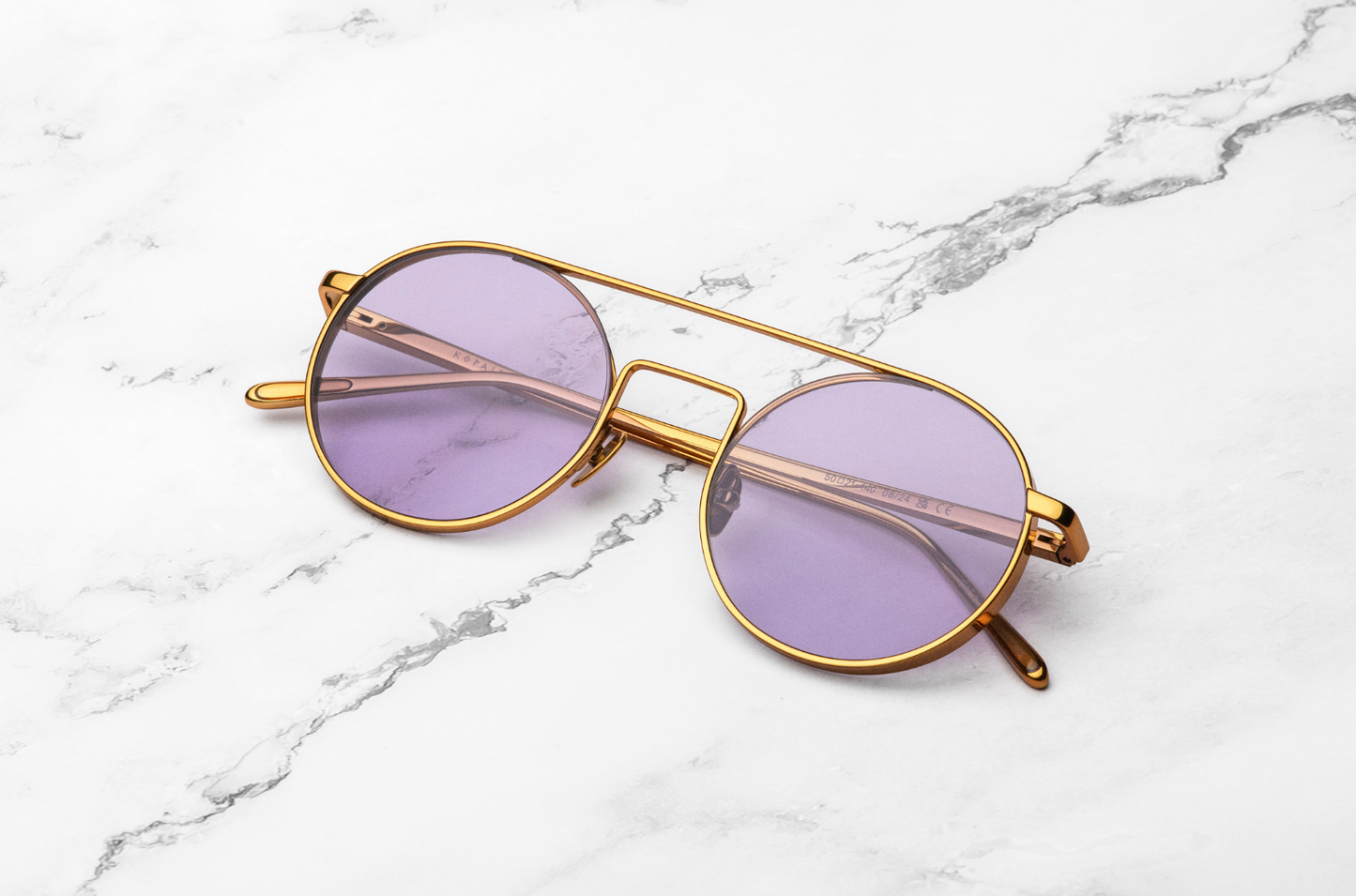 Gold round frame sunglasses with liliac lenses