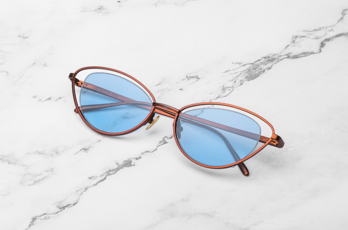 Bronze cat eye sunglasses for women with light blue lenses
