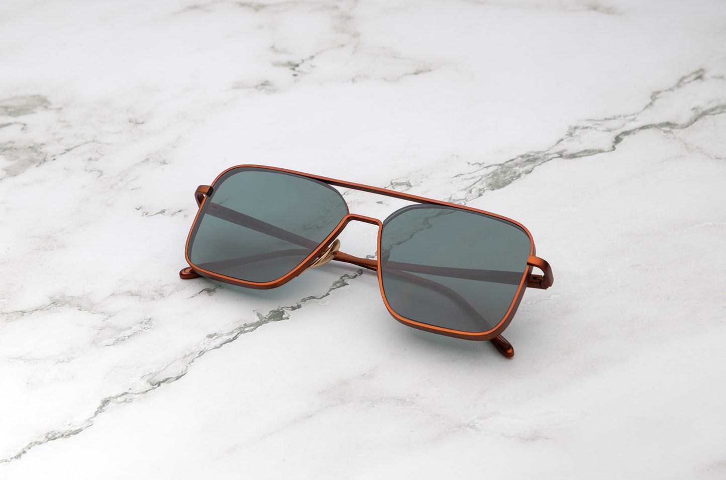 Bronze aviator sunglasses with dark green polarized lenses by Kopajos