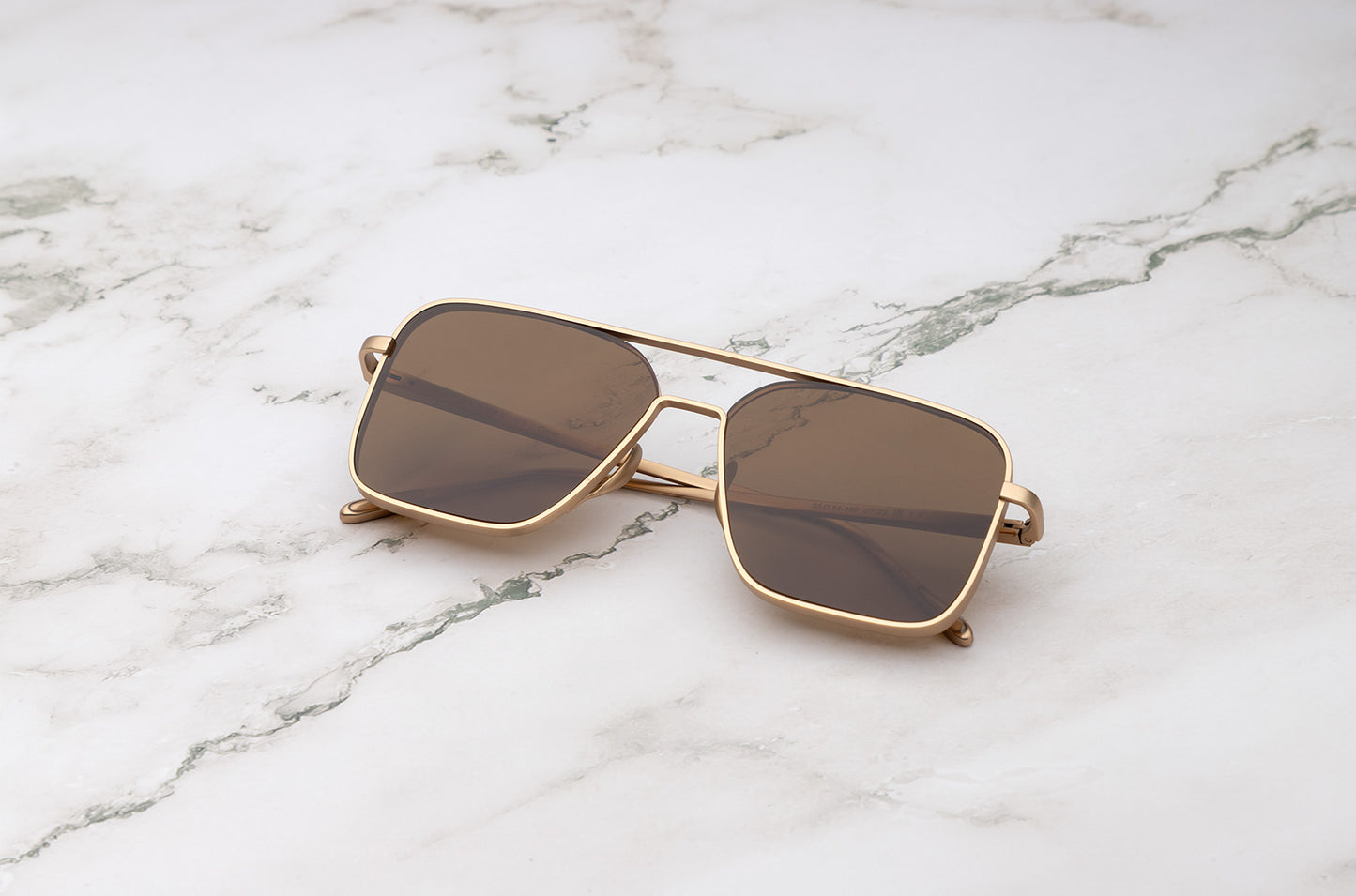Gold aviator sunglasses with brown polarized lenses by Kopajos