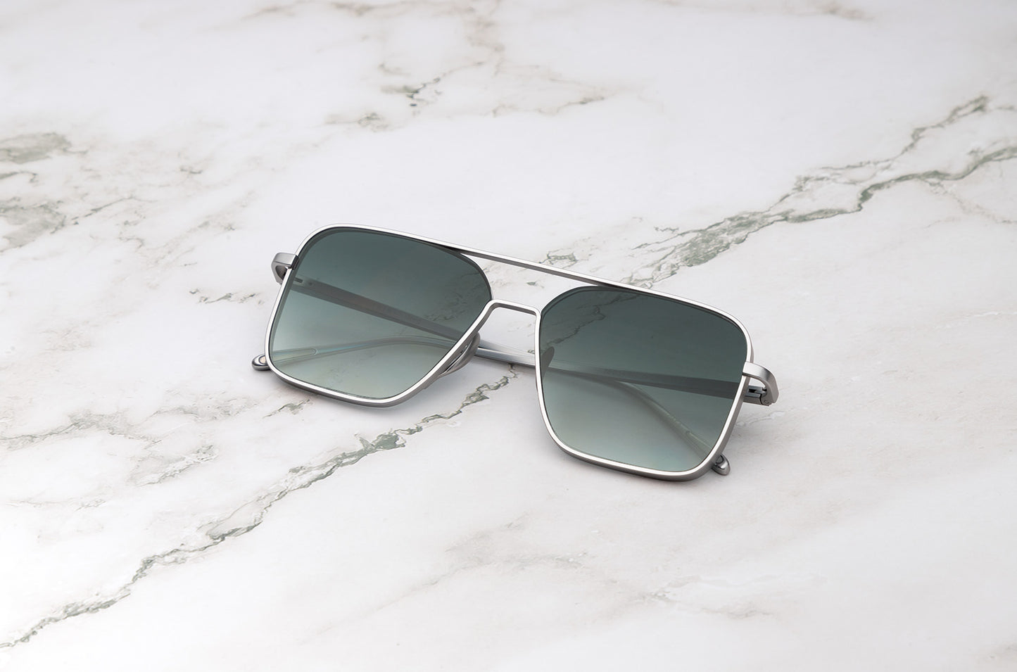 Silver aviator sunglasses with smokey green polarized lenses by Kopajos