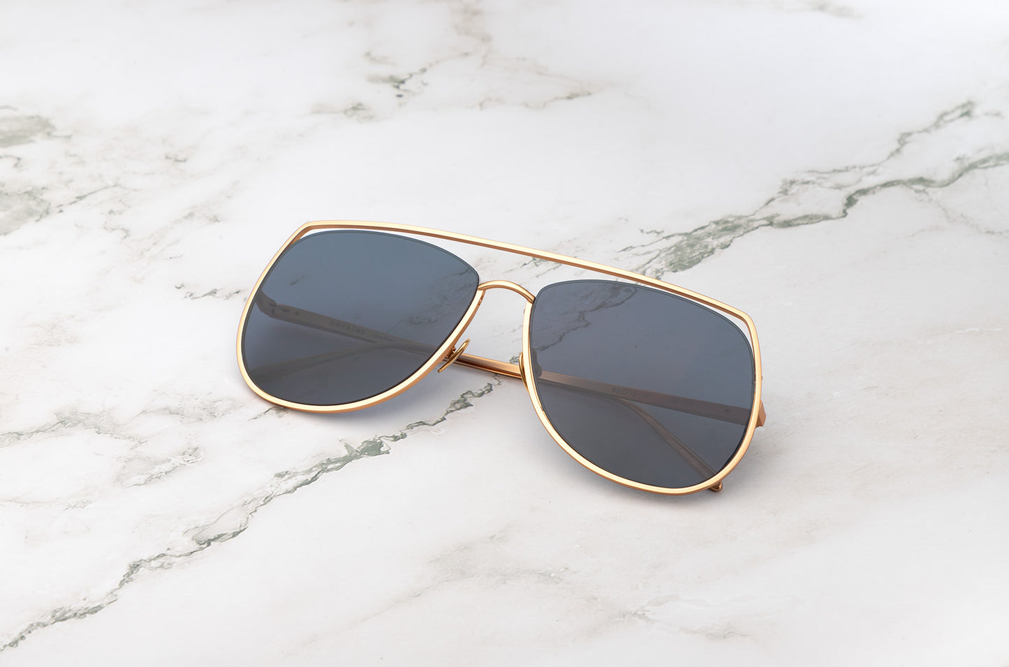 Gold aviator sunglasses with black polarized lenses by Kopajos