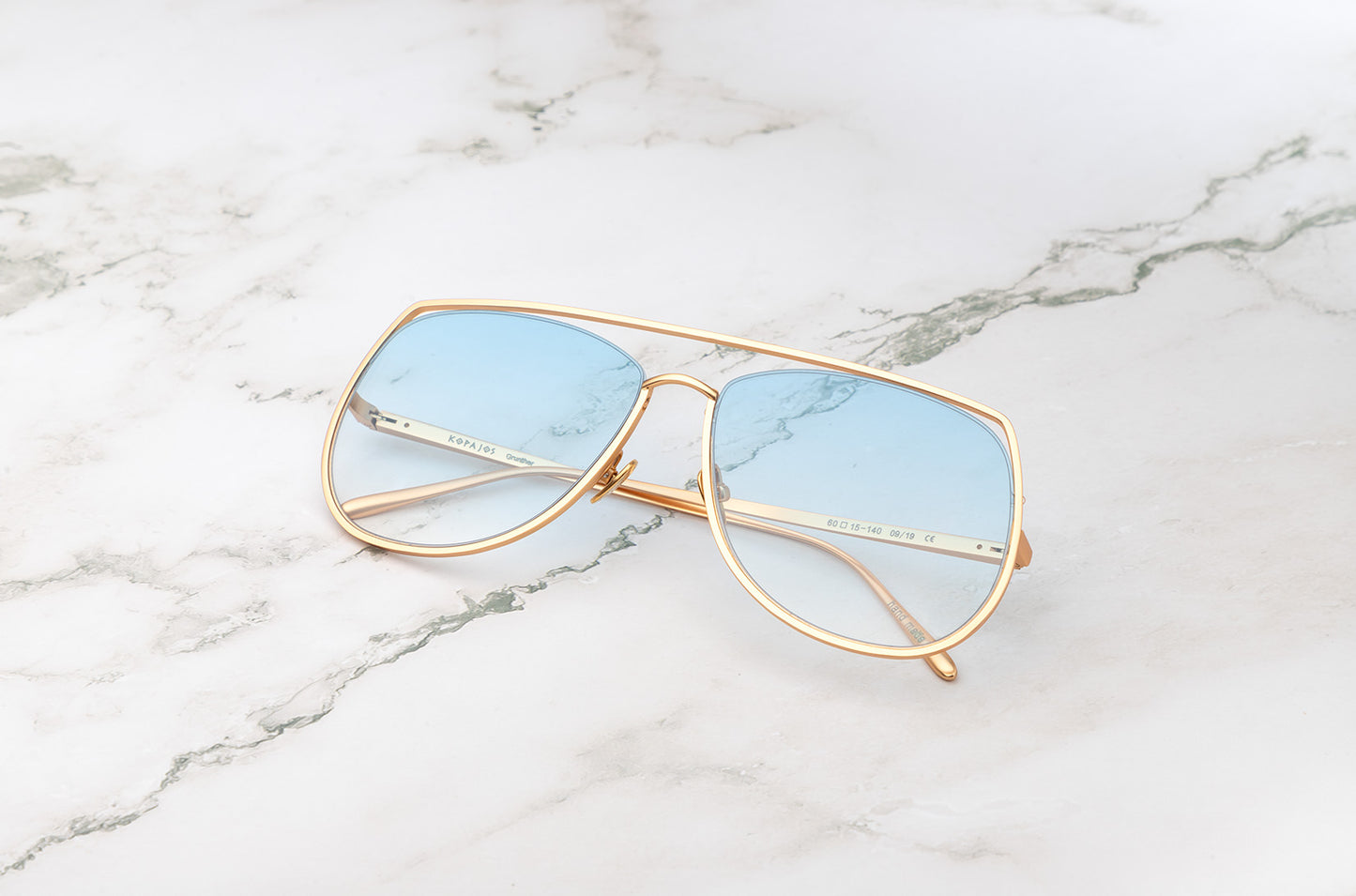 Gold aviator sunglasses with light blue polarized lenses by Kopajos