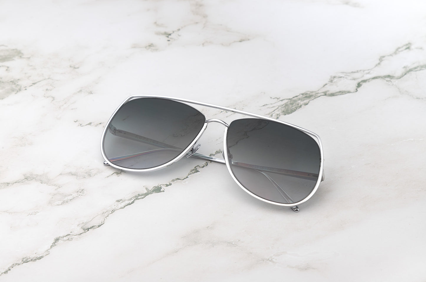 Silver aviator sunglasses with smokey green polarized lenses by Kopajos
