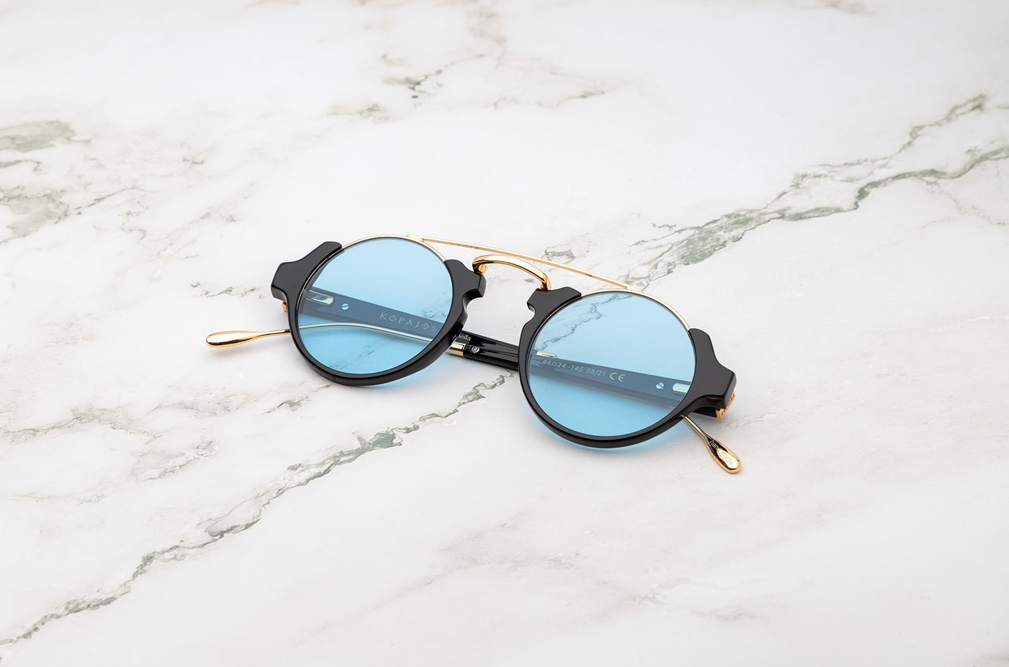 Black and gold round sunglasses for men with polarized light blue lenses by Kopajos