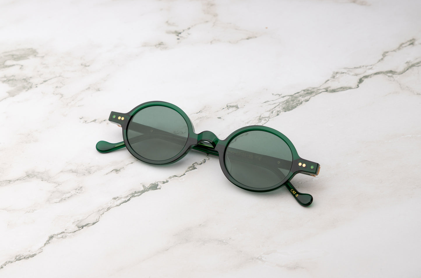 Green round sunglasses with dark polarized lenses by Kopajos