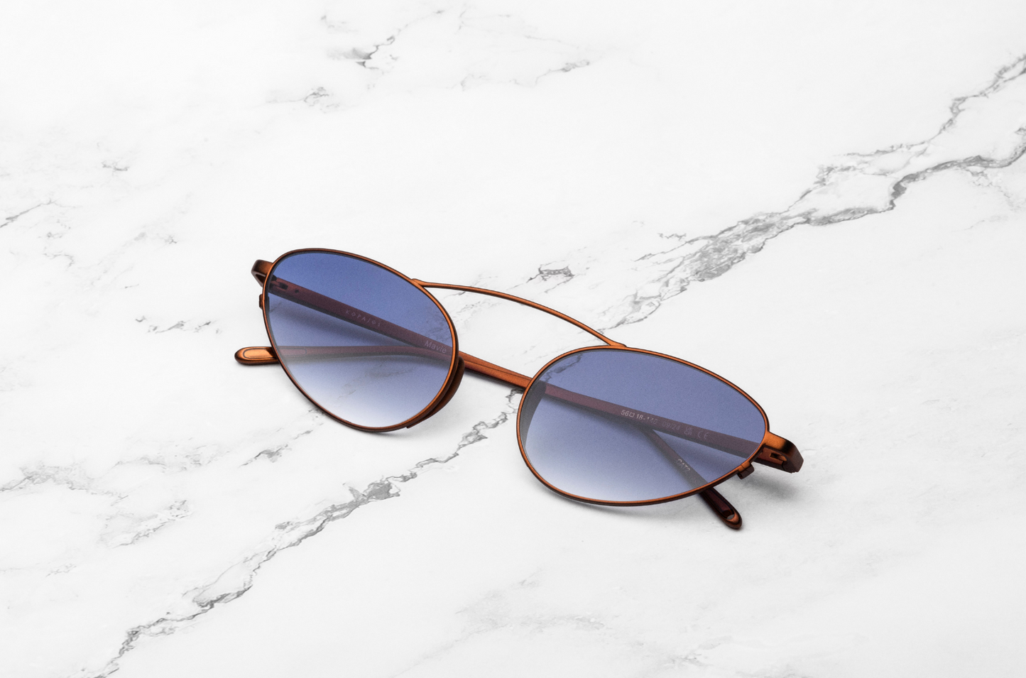 Bronze female cat eye sunglasses with smokey blue lenses by Kopajos