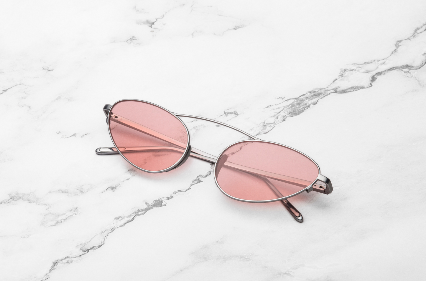 Silver female cat eye sunglasses with pink lenses