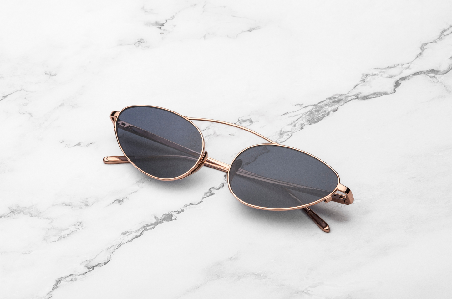 Rose Gold female cat eye sunglasses with dark lenses