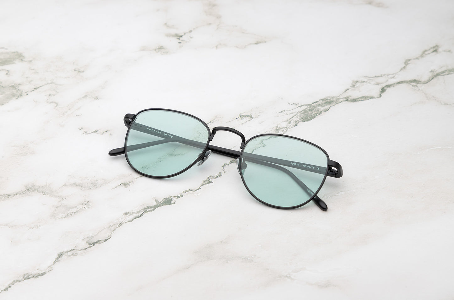 Black aviator sunglasses with light green polarized lenses by Kopajos