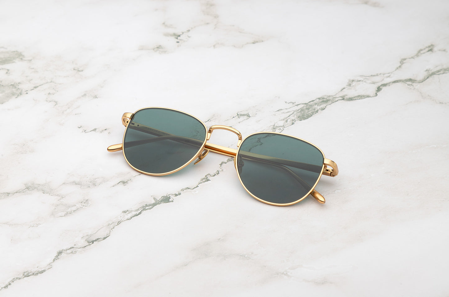 Gold aviator sunglasses with dark green lenses by Kopajos