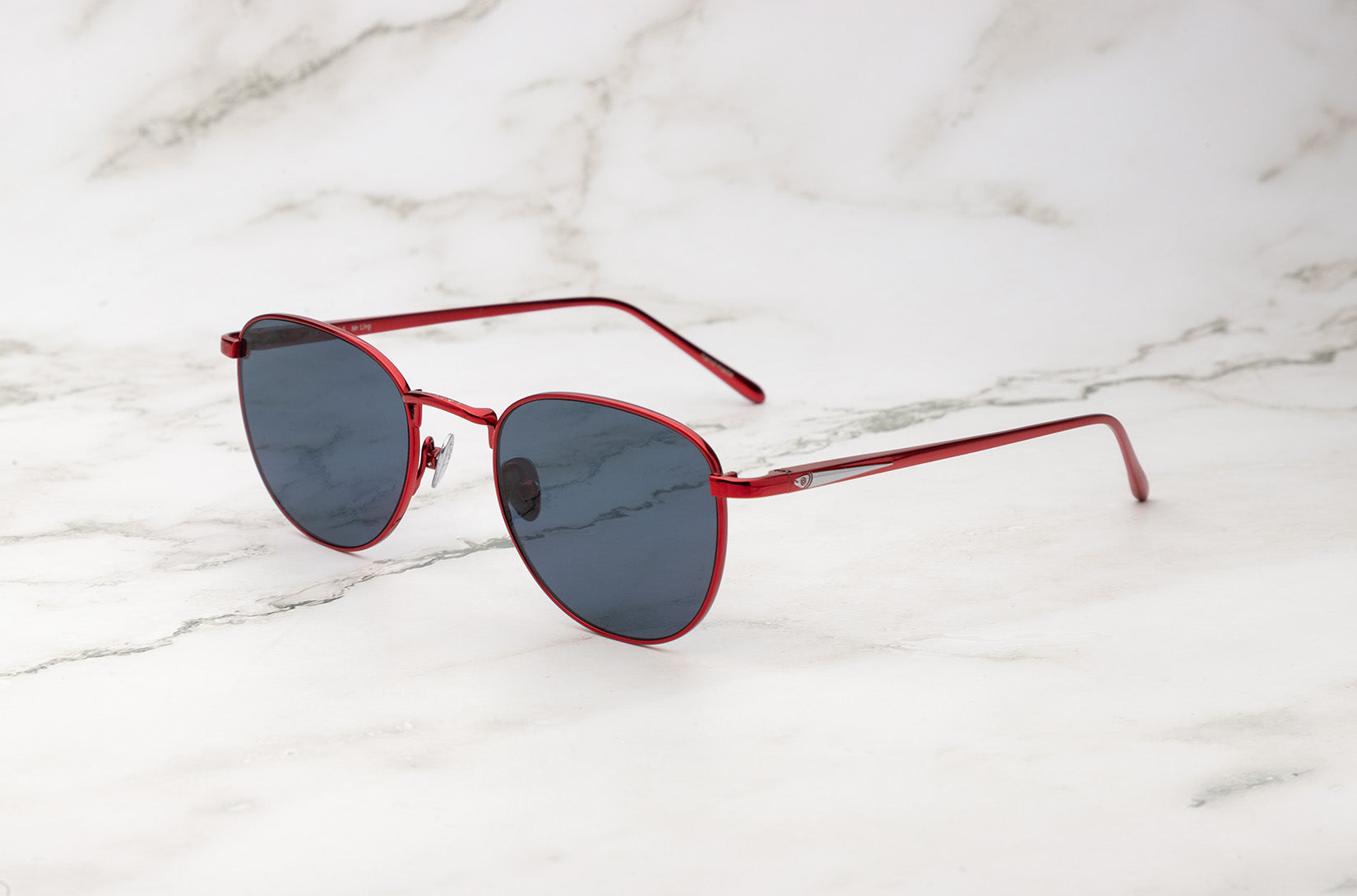 Red aviator sunglasses with dark polarized lenses by Kopajos