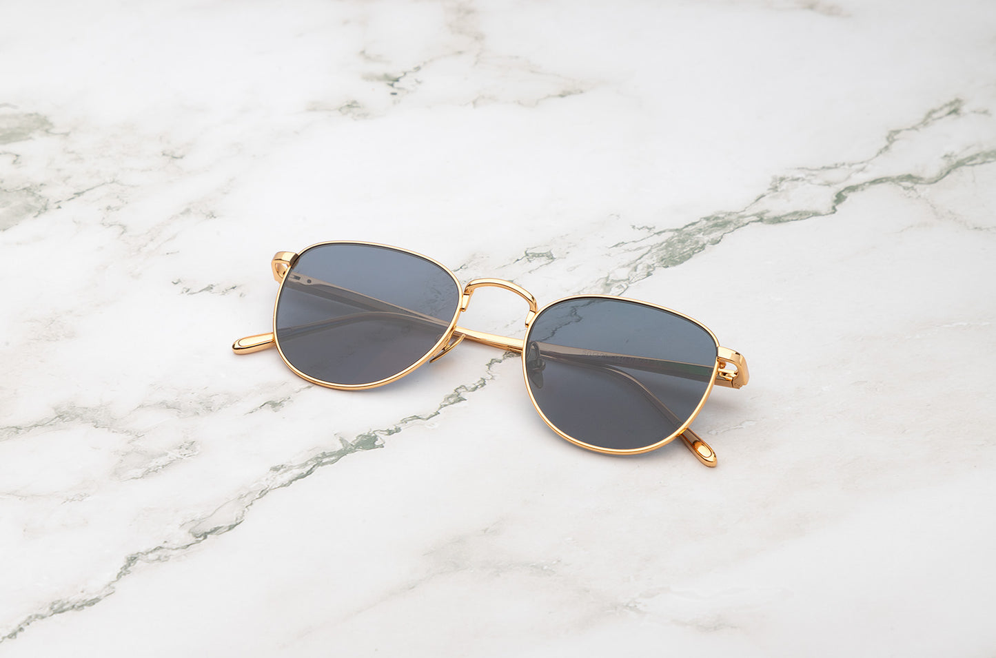 Gold aviator sunglasses with dark polarized lenses by Kopajos
