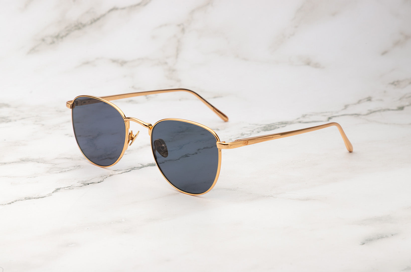 Gold aviator sunglasses with dark polarized lenses by Kopajos