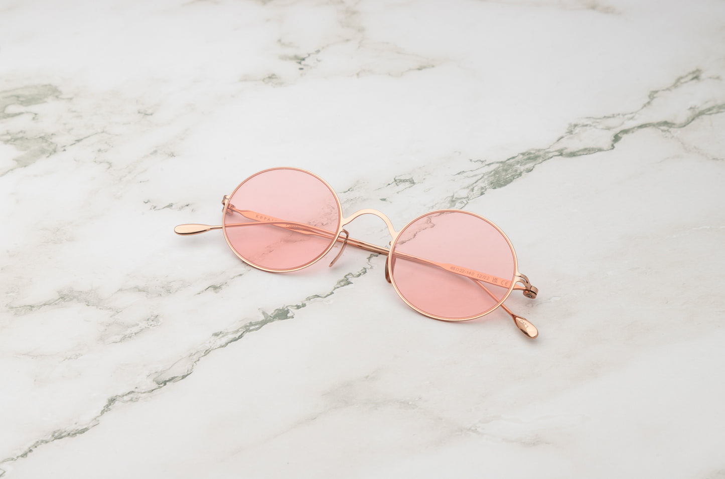 Rose gold round sunglasses for women with polarized pink lenses by Kopajos