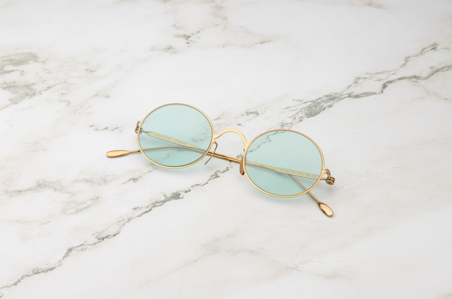 Gold round sunglasses for men and women with polarized light green lenses by Kopajos