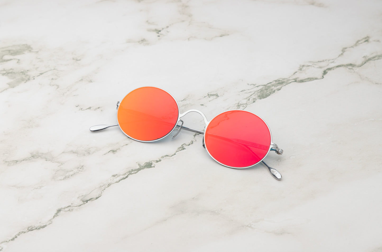 Silver oval sunglasses for men and women with polarized red lenses by Kopajos