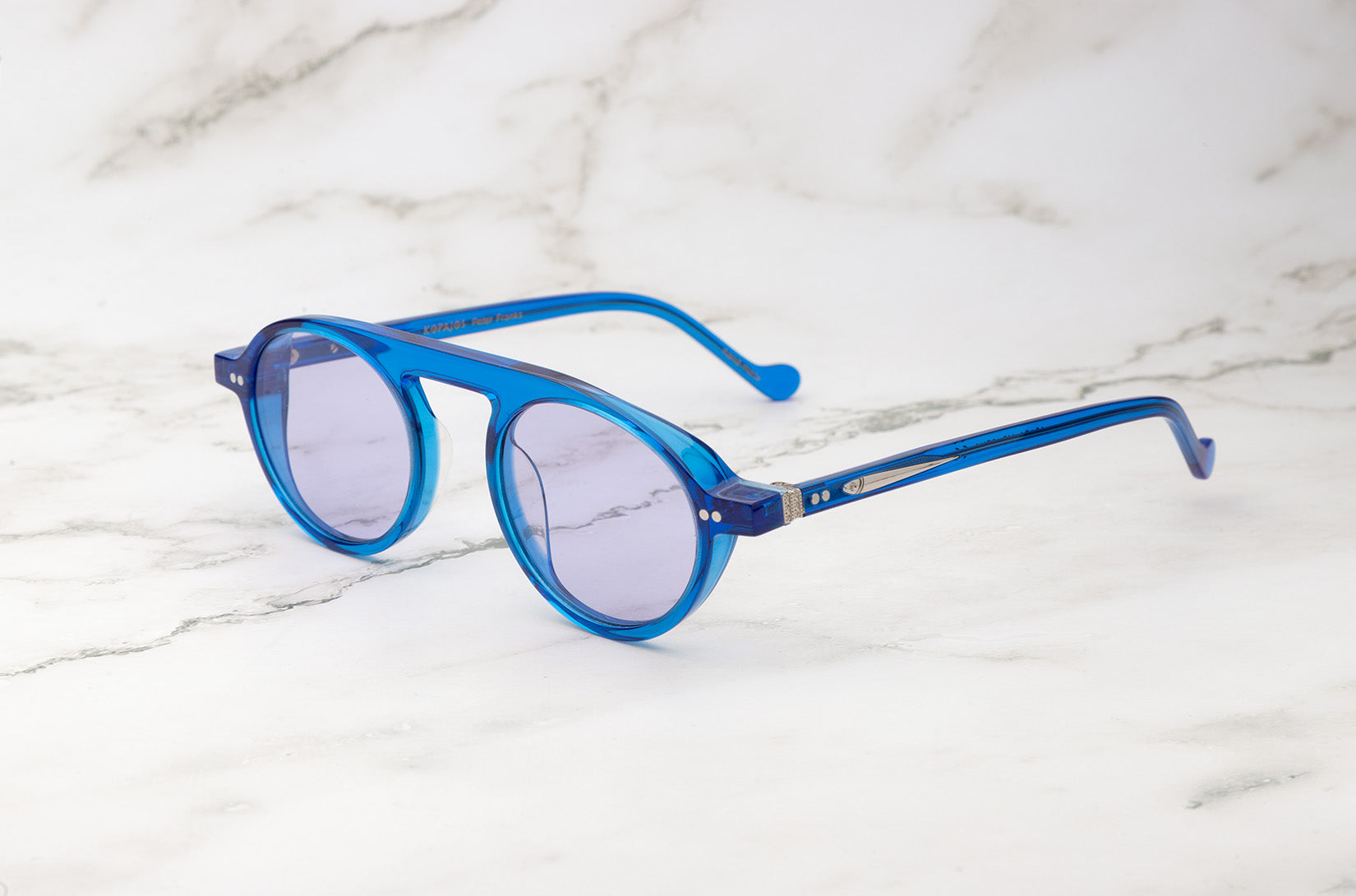 Tiny round sunglasses by Peter Frank for a minimalist style.