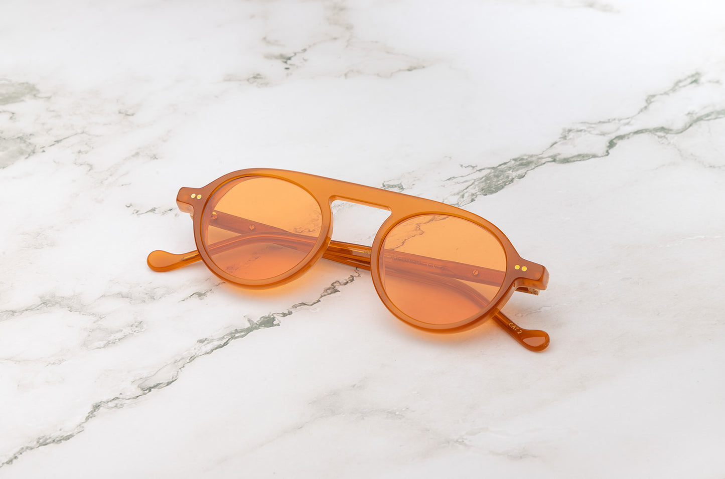 Peter Frank orange round sunglasses female model.
