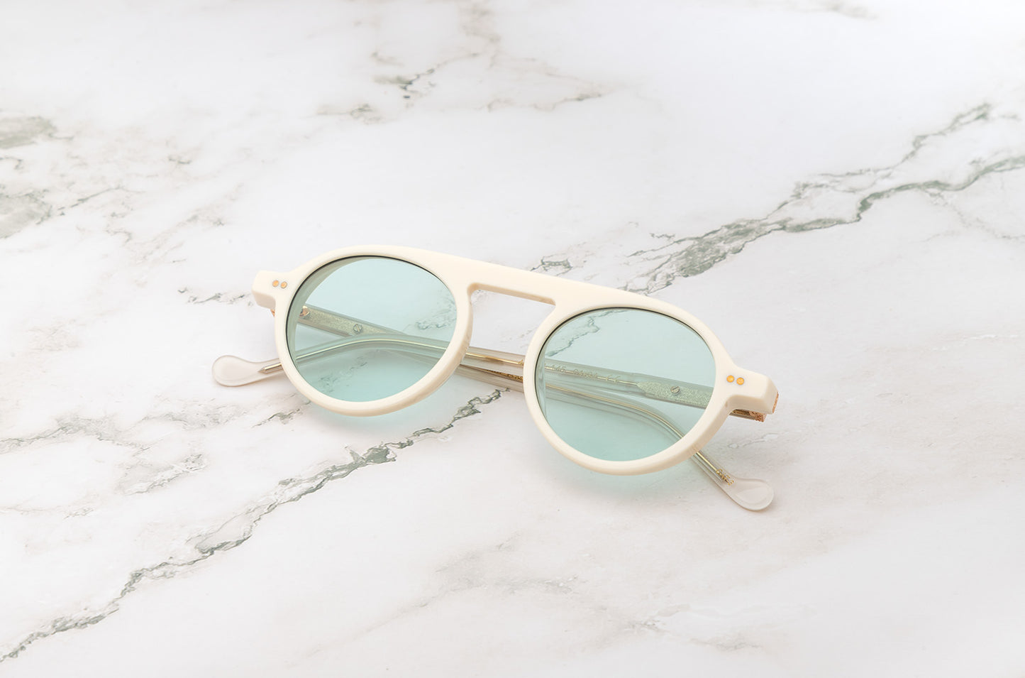 Peter Frank's small round sunglasses for women in a white frame.