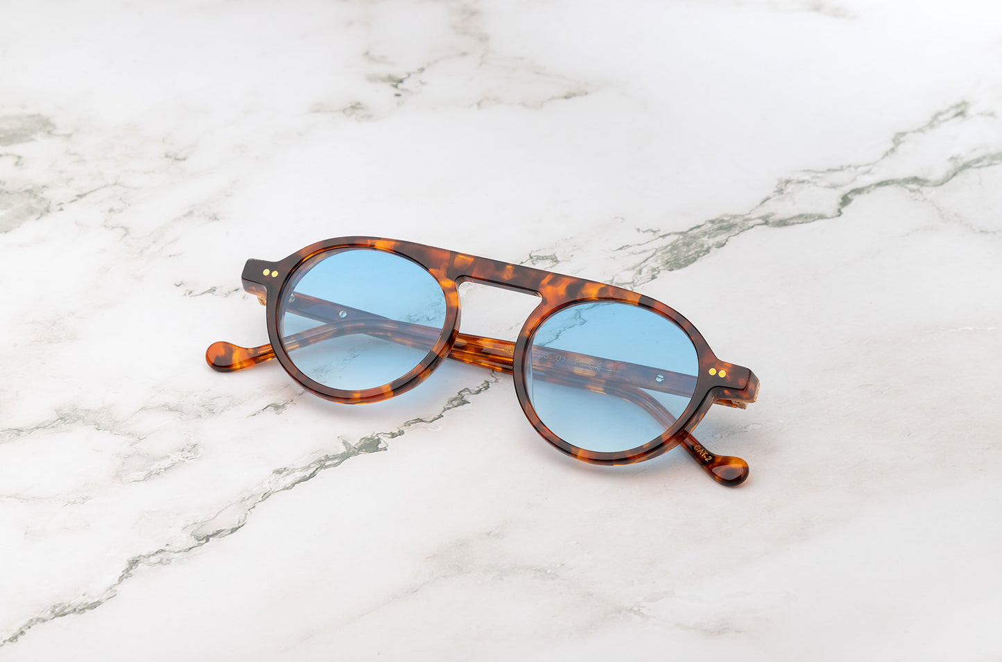 A detailed look at the craftsmanship of Peter Frank's round frame sunglasses.