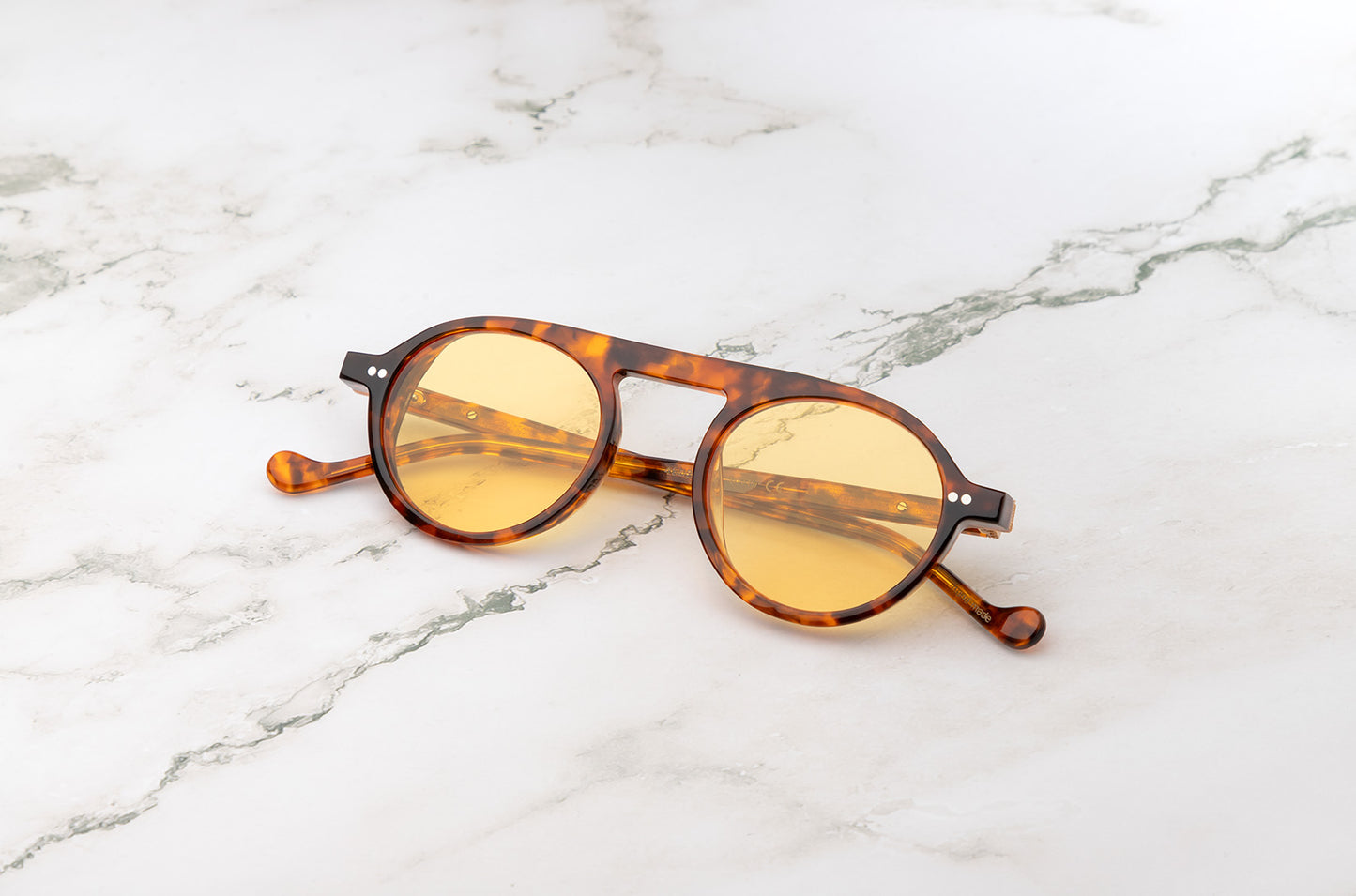 The Peter Frank vintage round circle sunglasses on a table.