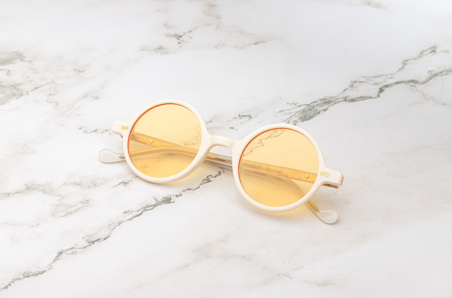 The lightweight and durable Kopajos Petra round sunglasses with white frame and yellow polarized lenses