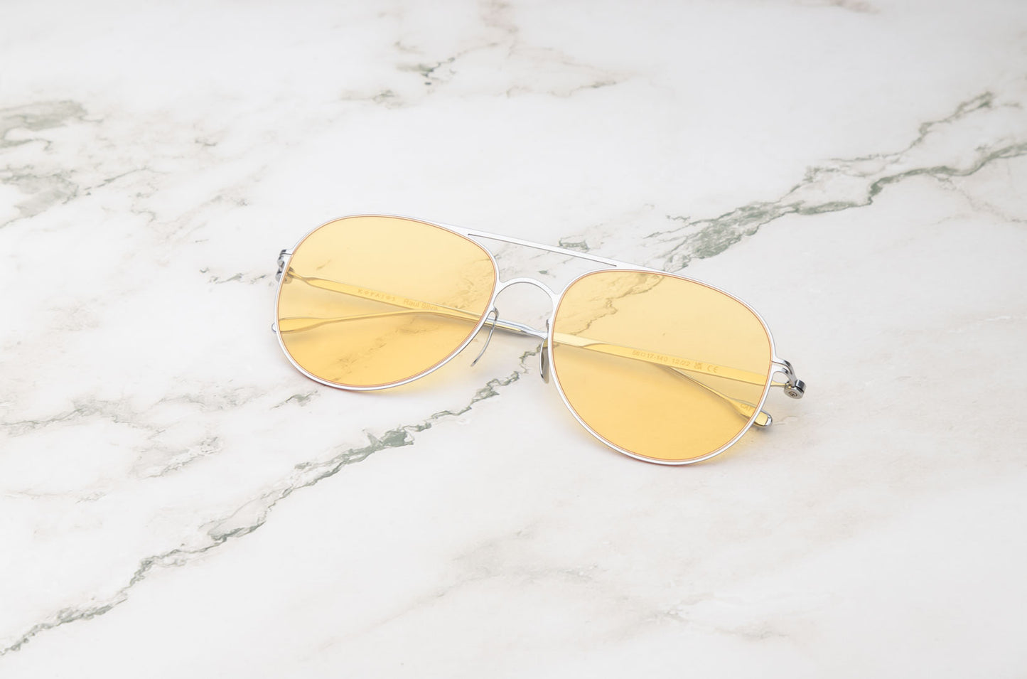 From Santorini shores to city streets: the Kopajos Raul Silva silver and yellow aviator sunglasses.