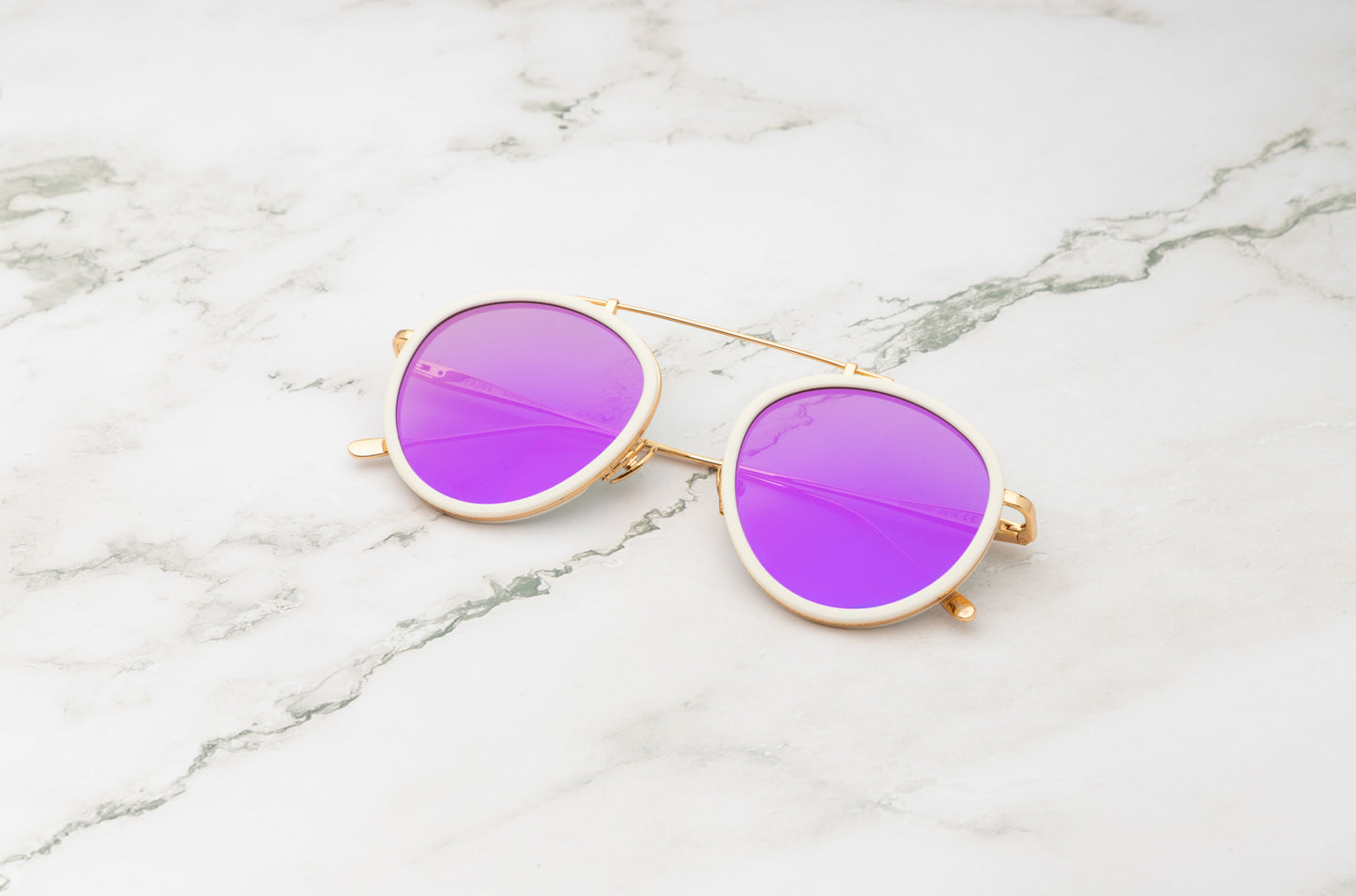 A pair of vintage gold aviator sunglasses, the timeless Sasha Davidov model.