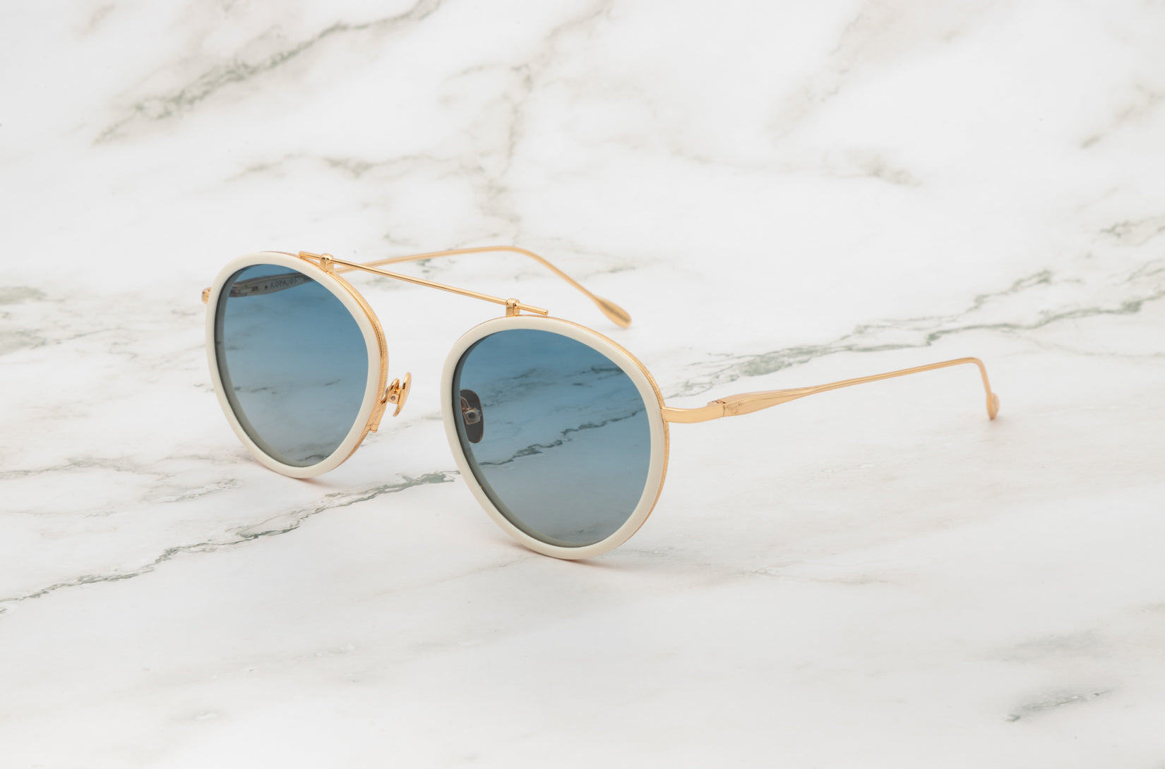 The Sasha Davidov aviator sunglasses with classic dark lenses by Kopajos.