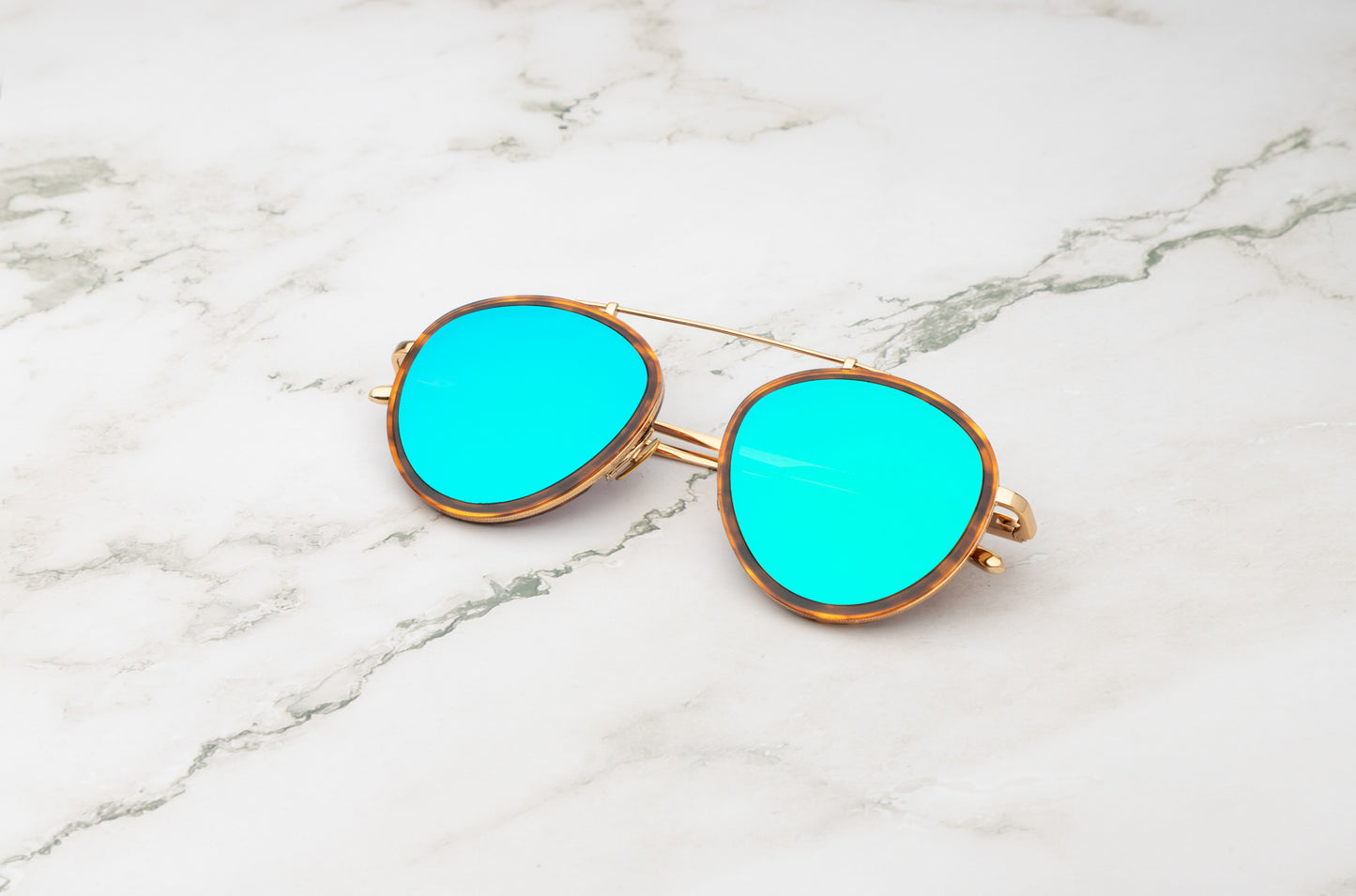 Kopajos Sasha Davidov women's aviator sunglasses at a poolside in Miami.