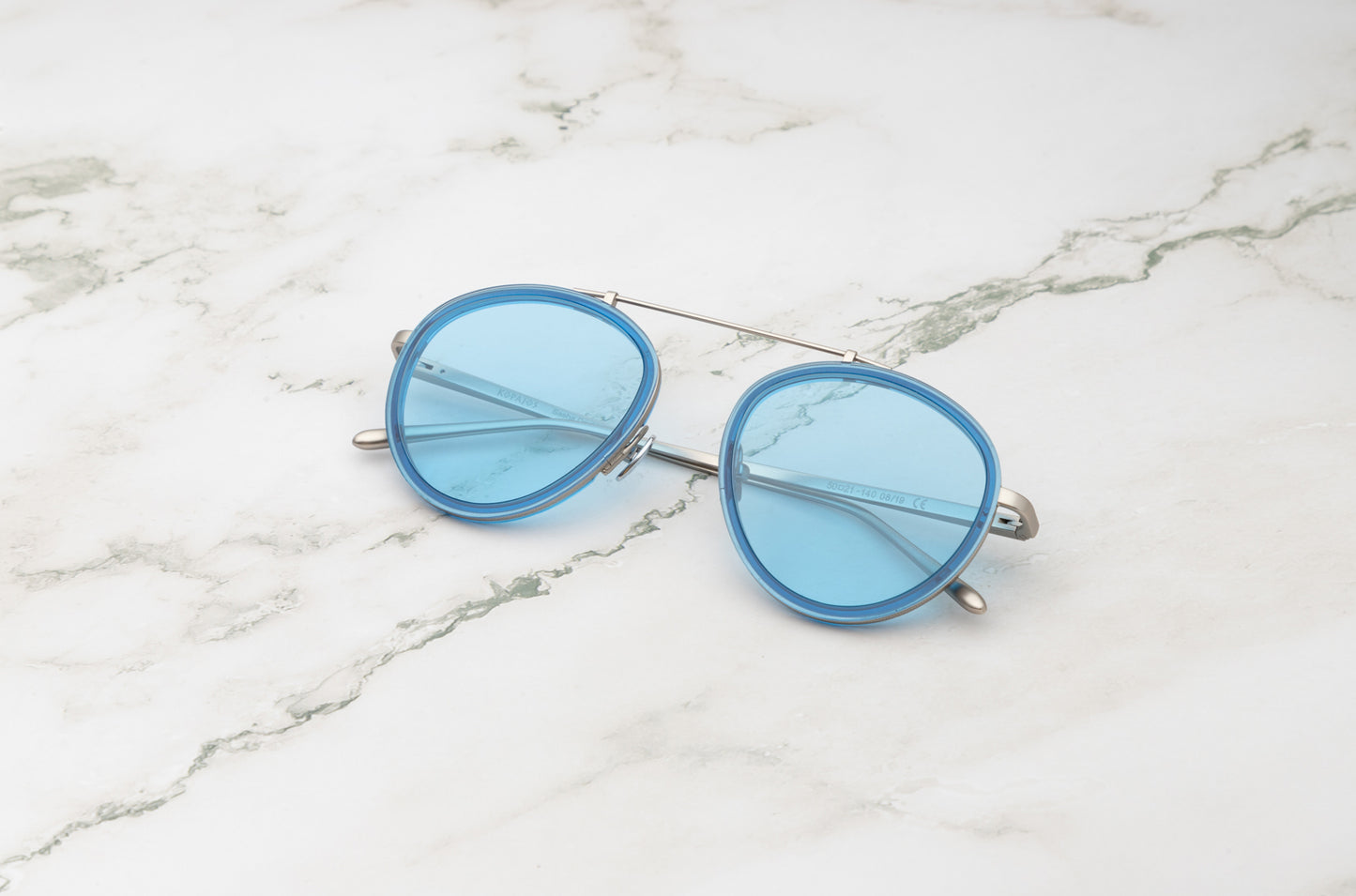 The unique color palette of the Kopajos Sasha Davidov light blueaviator sunglasses.