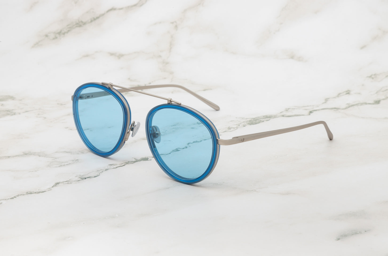 A detailed shot of the iconic Kopajos gold sunglasses aviator style, the Sasha Davidov.