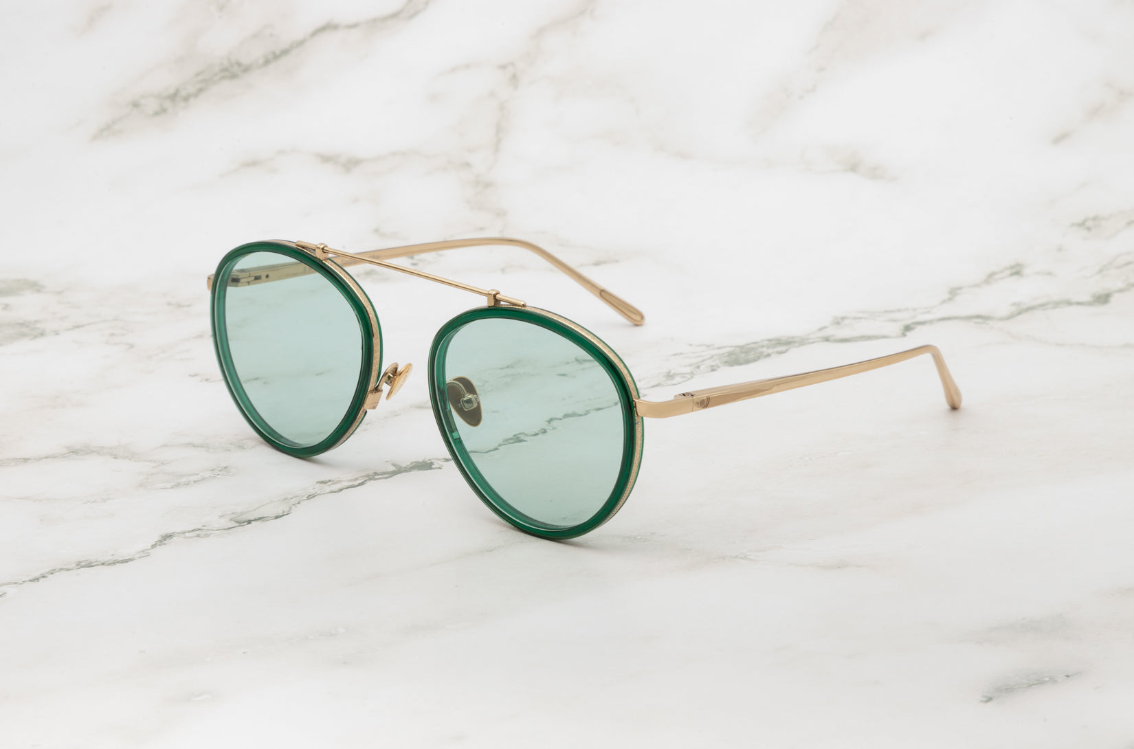 A bold and unique choice: the Kopajos Sasha Davidov green aviator sunglasses.