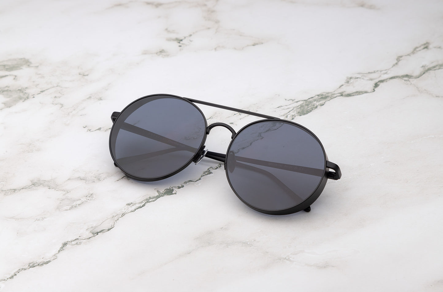 A close-up of the finely detailed Thunderball round metal sunglasses frame.
