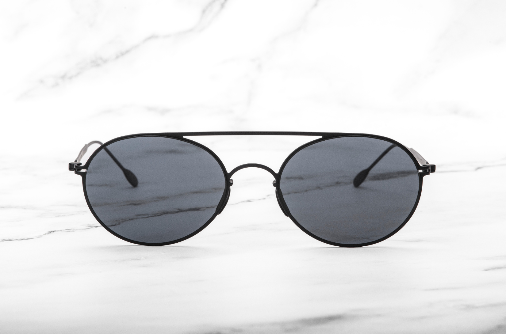 The Tracy, a pair of gracefully designed round sunglasses by Kopajos.
