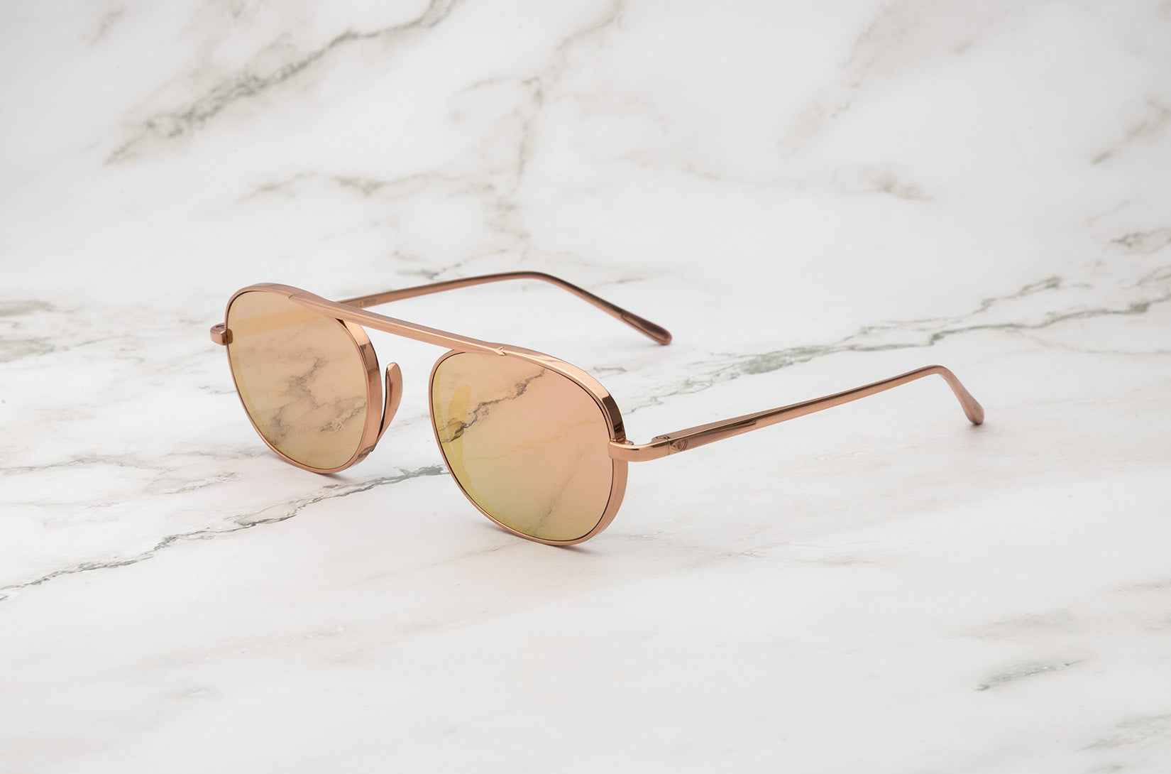 Rose Gold round sunglasses female model.