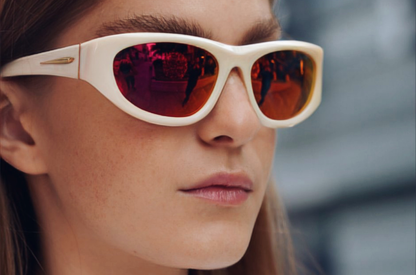 Model showcasing Gogol mask sunglasses by Kopayos featuring white frame and colorful polarized lenses.