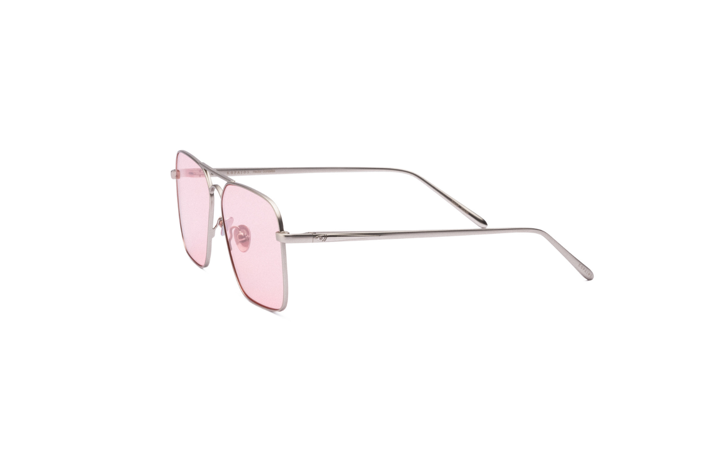 Hector Gonzales aviator sunglasses by Kopajos with silver frame and pink polarized lenses, shown from the side.
