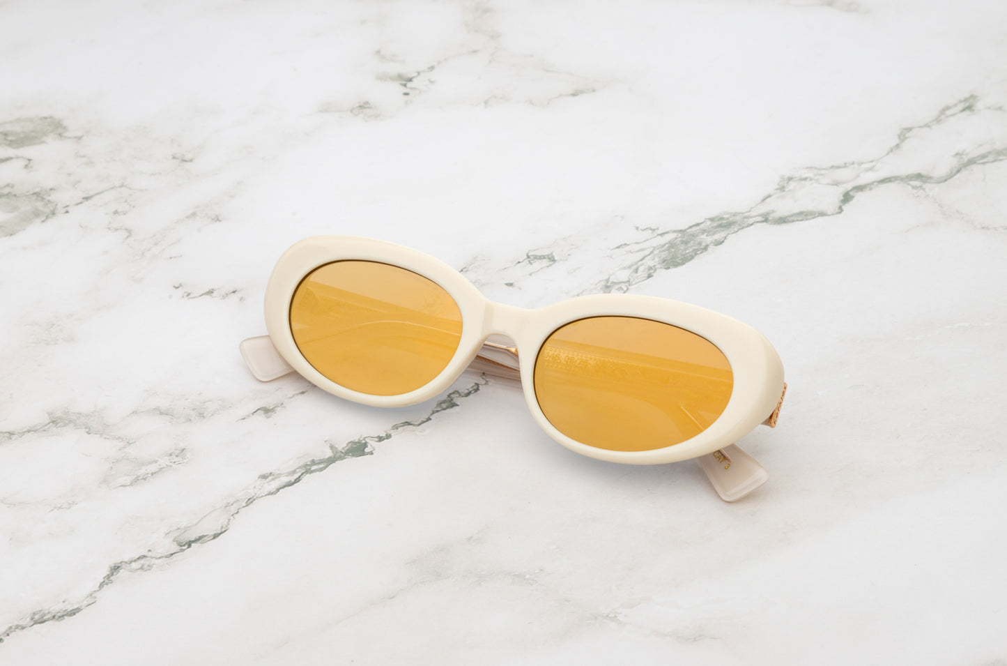 Lina round sunglasses by Kopajos with white frame and gold mirrored polarized lenses for men and women.