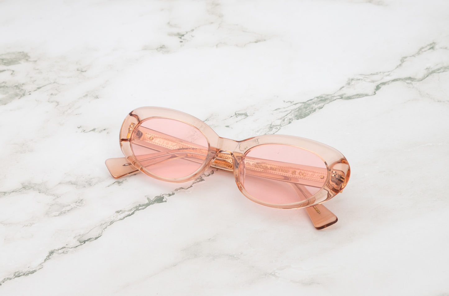 Lina round sunglasses by Kopajos with transparent pink frame and transparent pink polarized lenses for men and women.