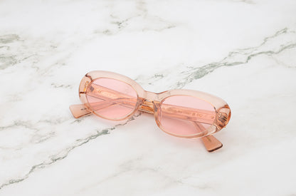 Lina round sunglasses by Kopajos with transparent pink frame and transparent pink polarized lenses for men and women.