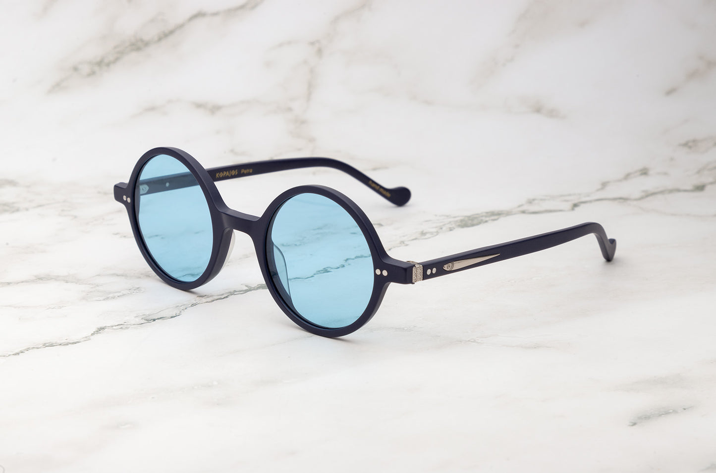 Kopajos Petra large round sunglasses with black frame and light blue lenses
