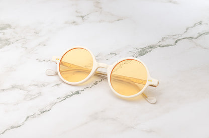 The lightweight and durable Kopajos Petra round sunglasses with white frame and yellow polarized lenses