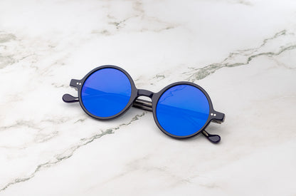 Kopajos Petra round sunglasses with black frame and blue polarized lenses

